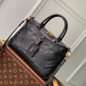 Replica Louis Vuitton Trianon bag in monogram empreinte leather, held by a woman, high-quality designer dupe with free shipping (9)